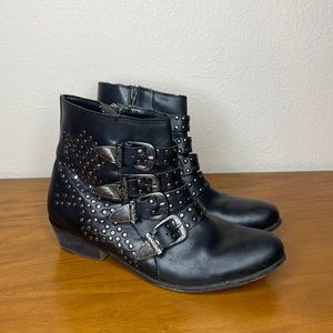 Black faux leather with silver studs and buckles